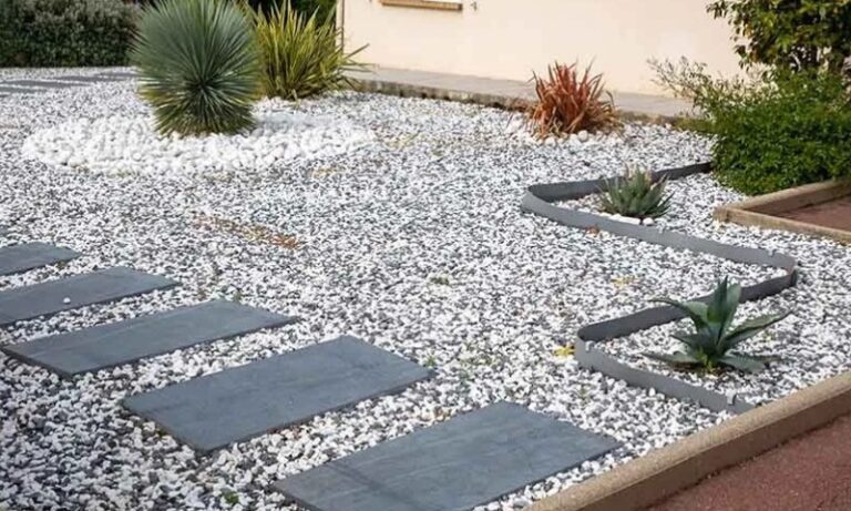 Modern front yard with a gravel landscape, featuring geometric stone paths and desert plants like succulents