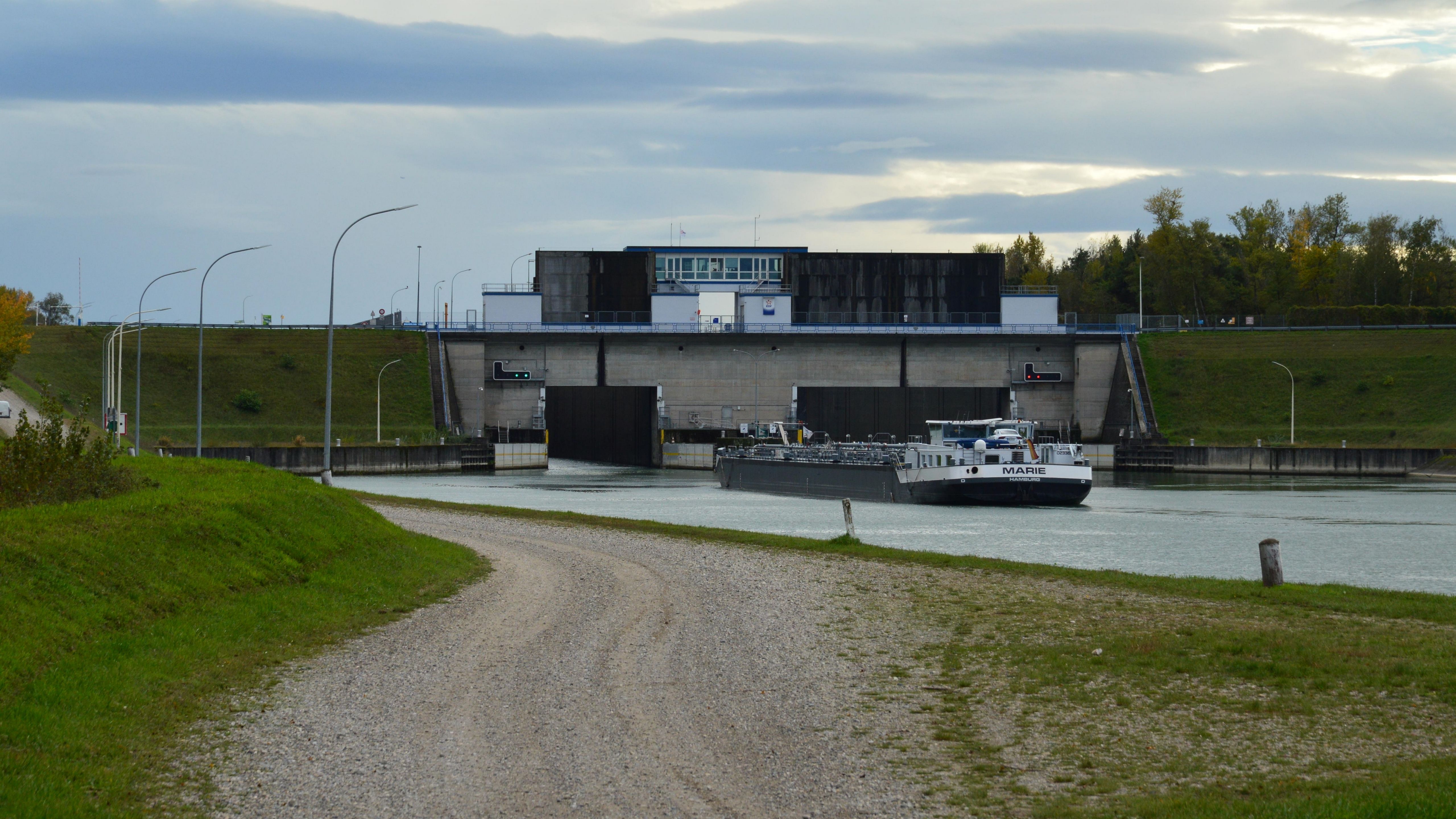Cargo barge entering a river canal lock, a key bottleneck for Danube freight navigation